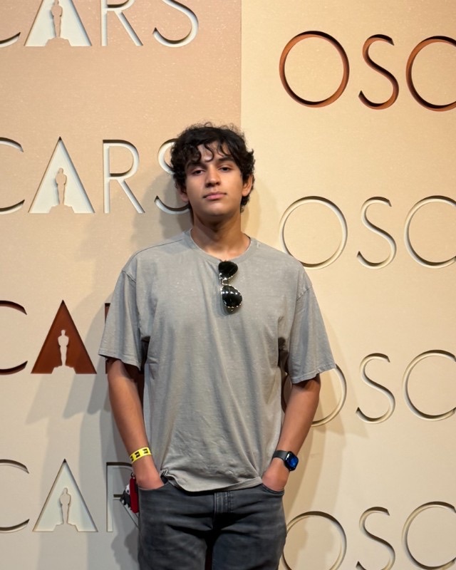 Arnav Podichetty in front of an Oscars backdrop at the Academy Museum of Motion Pictures